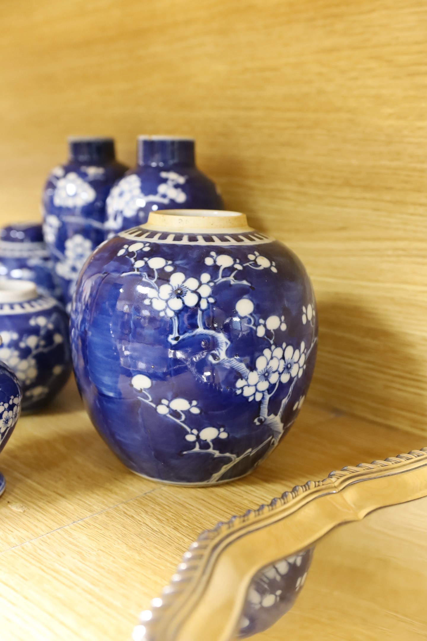 A group of Chinese blue and white prunus vases and jars and covers and jars, pair of vases 23 cms high